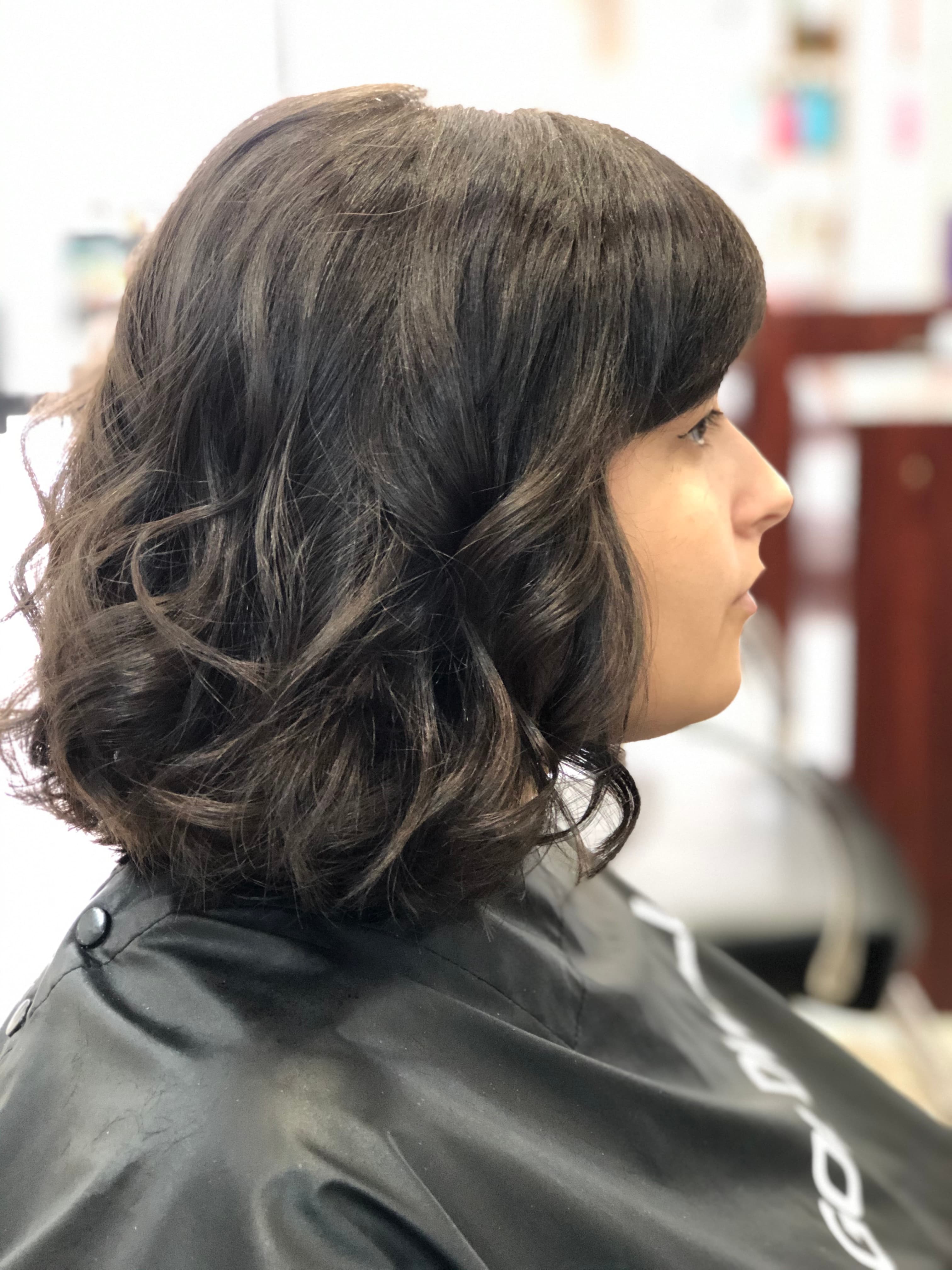 A modern, stylish haircut with clean lines and expertly crafted layers, showcasing a fresh and contemporary look.