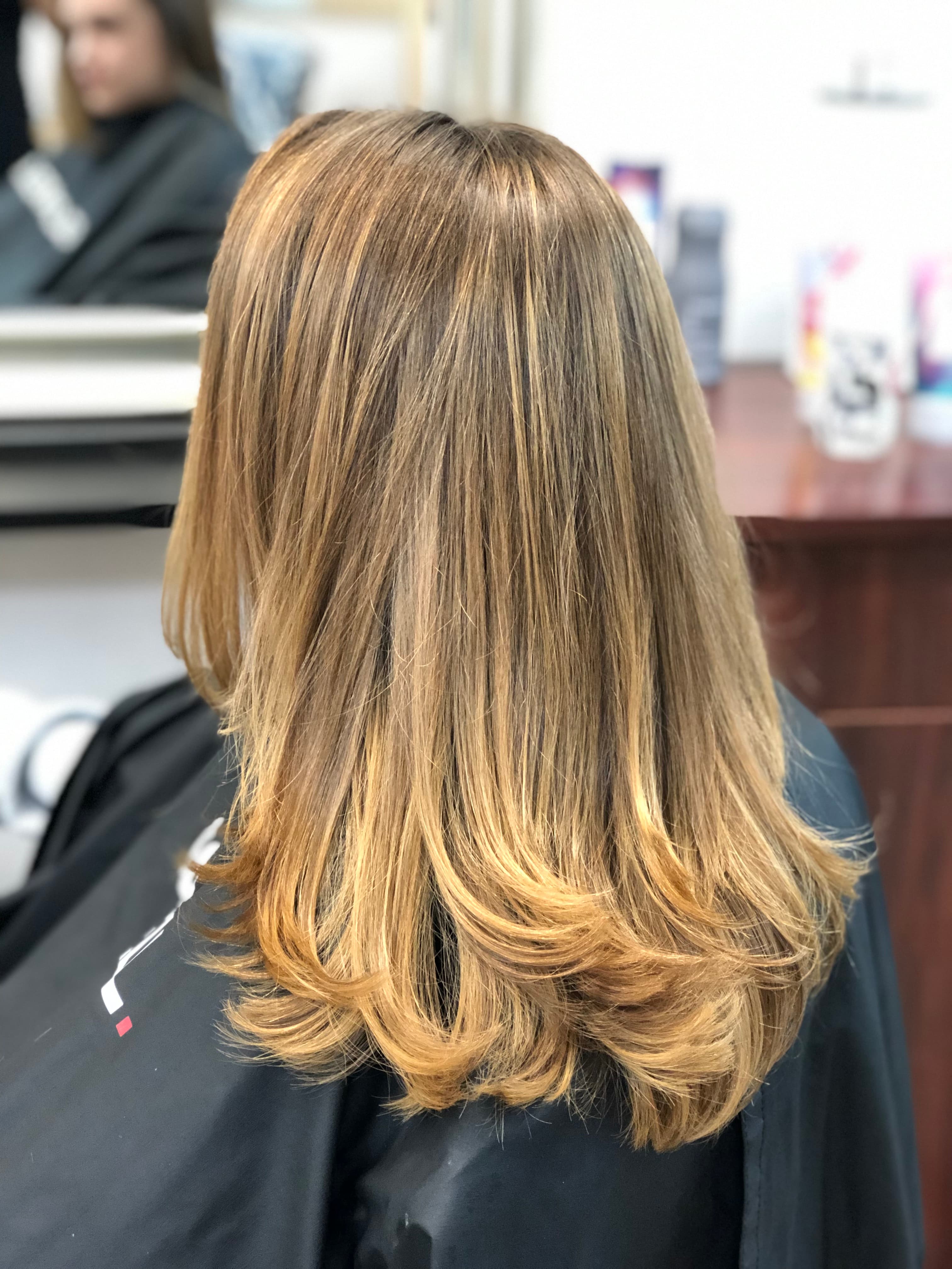 A modern, stylish haircut with clean lines and expertly crafted layers, showcasing a fresh and contemporary look.